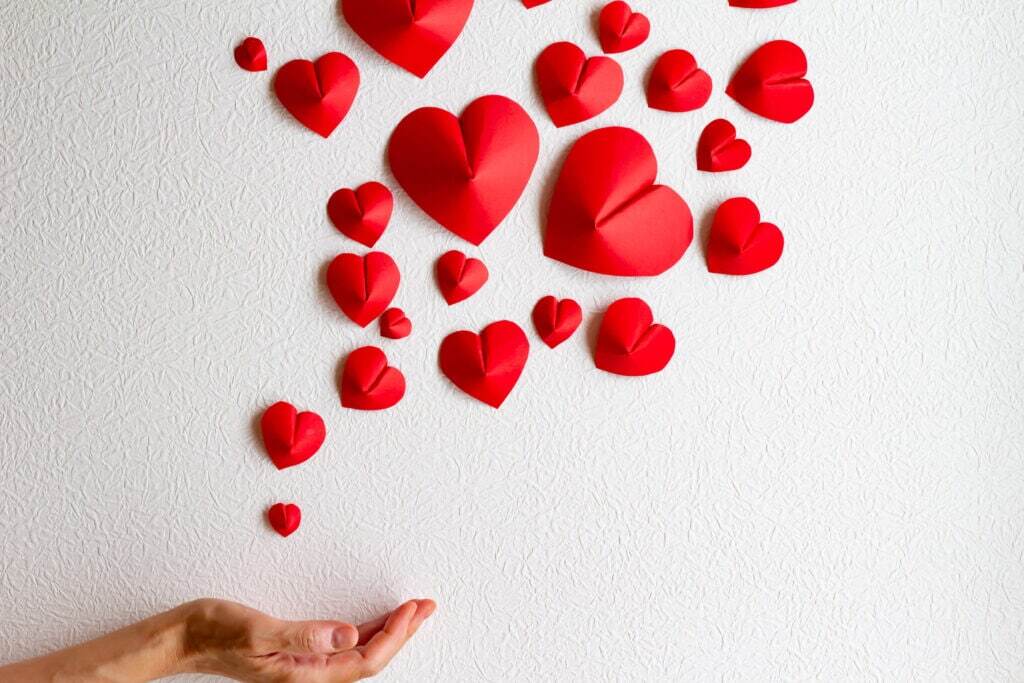 Heart-shaped folded paper on a white background.